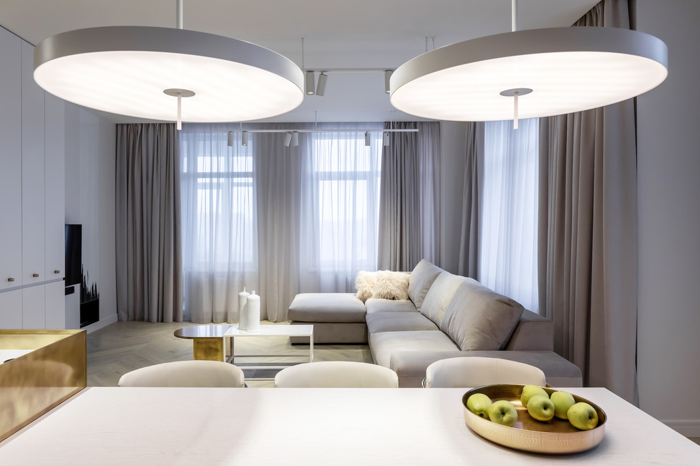 Стильный дизайн: большая открытая гостиная комната в современном стиле с белыми стенами, светлым паркетным полом, двусторонним камином, телевизором на стене и коричневым полом - последний тренд