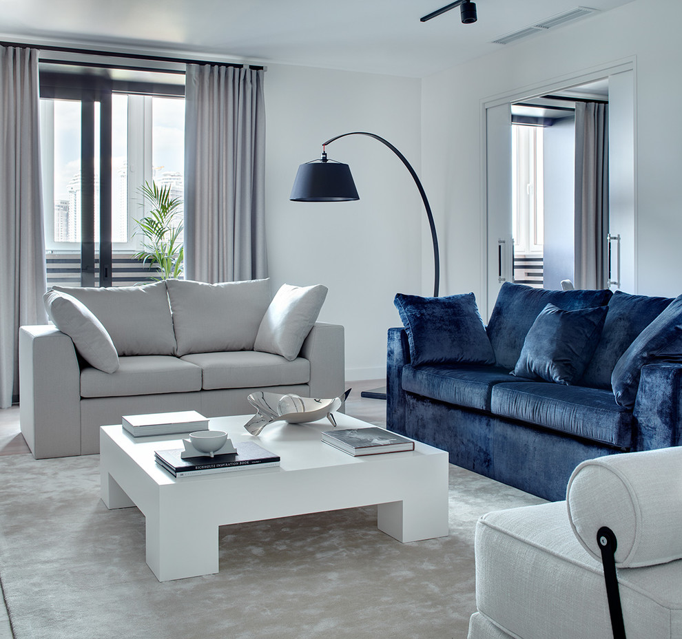 This is an example of a contemporary formal enclosed living room in Moscow with white walls, carpet and beige floors.