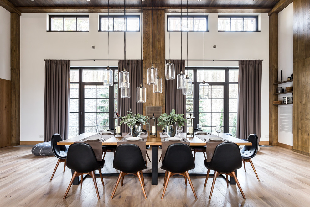 Design ideas for an expansive contemporary dining room in Moscow with white walls, medium hardwood flooring, a standard fireplace, a stone fireplace surround and brown floors.