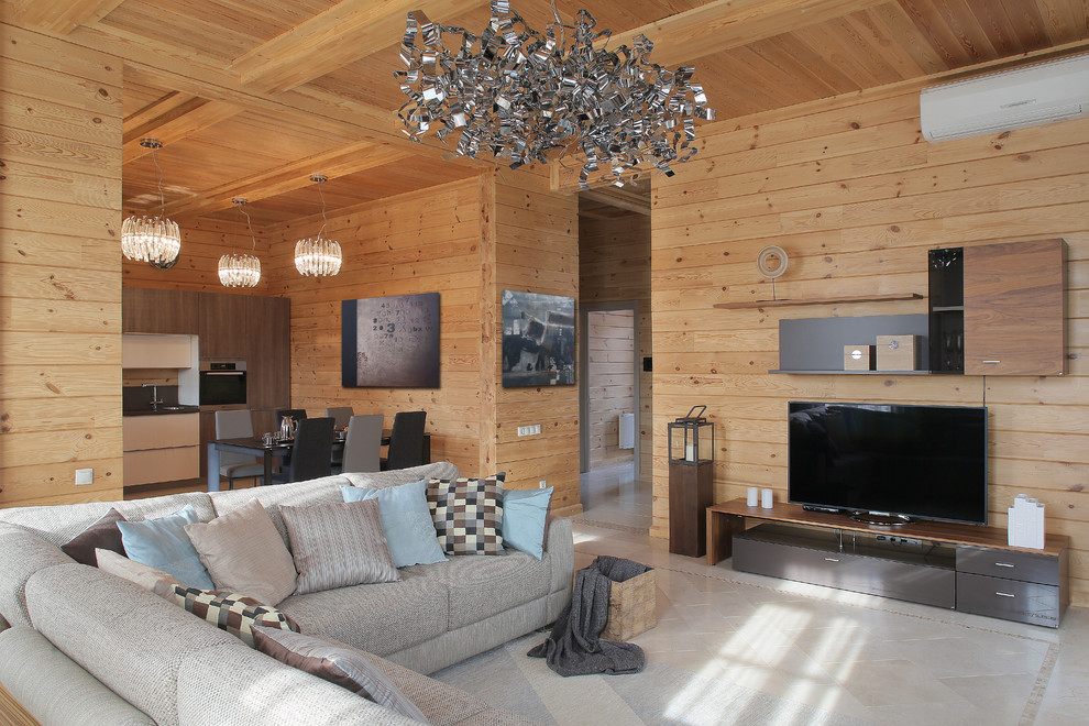 На фото: открытая гостиная комната среднего размера в стиле рустика с бежевыми стенами, полом из керамогранита, телевизором на стене и серым полом