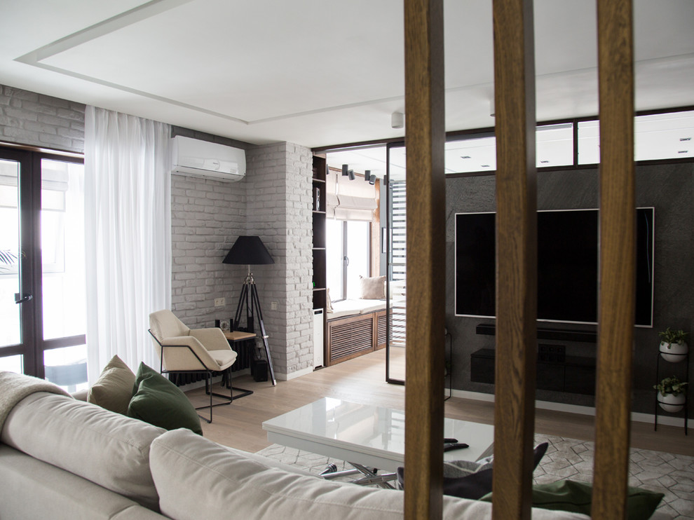 Foto di un soggiorno minimal di medie dimensioni e aperto con pareti grigie, pavimento in legno massello medio, camino lineare Ribbon e TV a parete