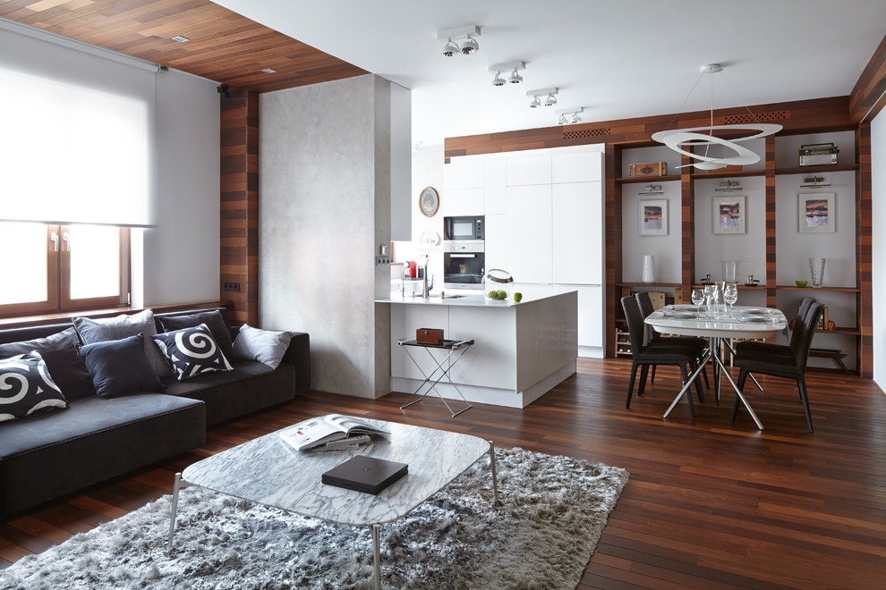 Idée de décoration pour un salon design ouvert avec une salle de réception, un mur blanc, parquet foncé et un sol marron.