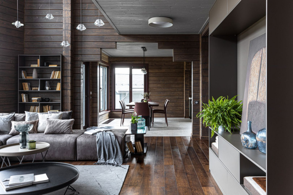 Large contemporary living room in Moscow with brown floors.