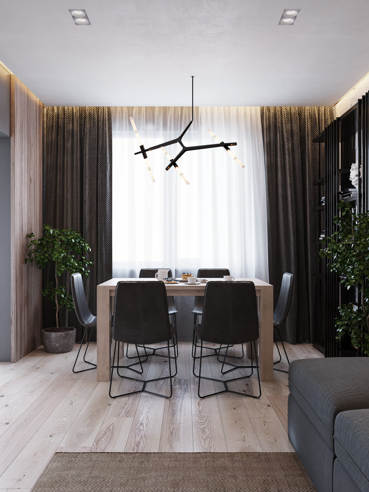 This is an example of a small contemporary dining room in Valencia with grey walls, light hardwood flooring and beige floors.