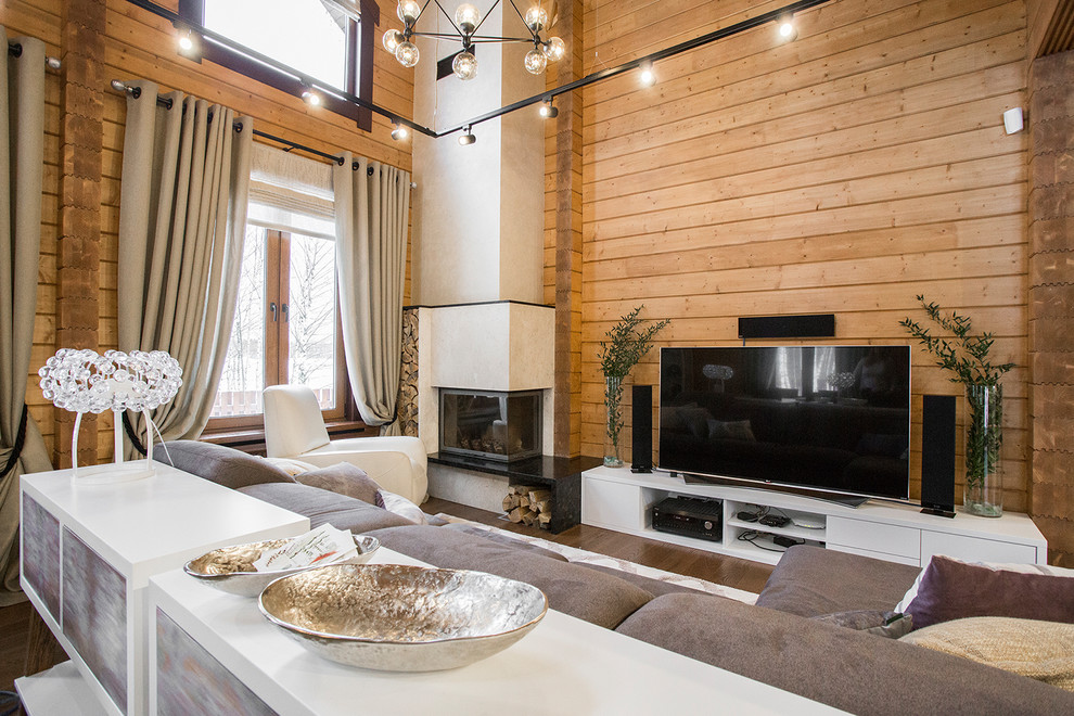 На фото: парадная, открытая гостиная комната среднего размера в современном стиле с коричневыми стенами, паркетным полом среднего тона и угловым камином с