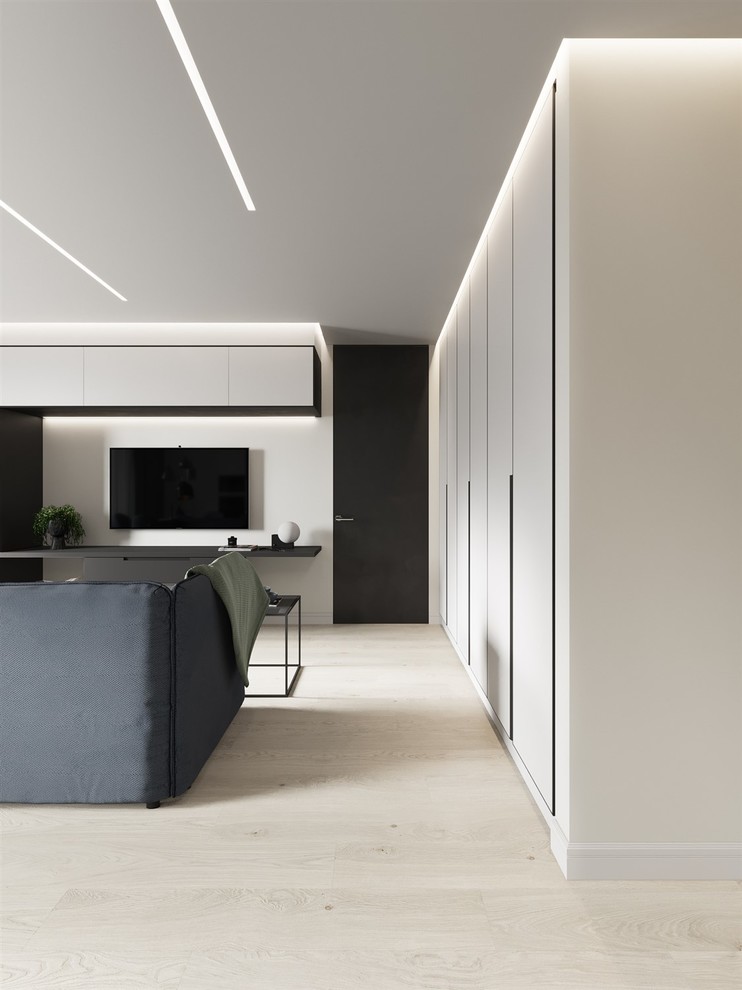Immagine di un soggiorno contemporaneo di medie dimensioni e aperto con pareti bianche, pavimento in laminato, TV a parete e pavimento beige
