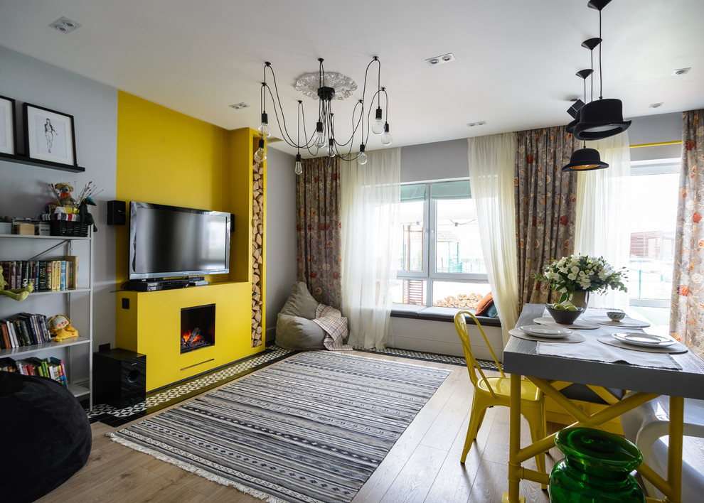 Idee per un soggiorno contemporaneo aperto con sala formale, pareti grigie, pavimento in legno massello medio, camino classico, TV autoportante, pavimento marrone e divano davanti alla finestra