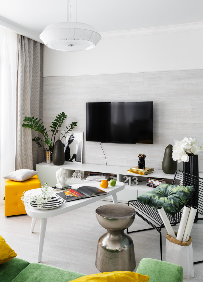 Inspiration for a contemporary living room in Other with white walls, a wall mounted tv and grey floors.