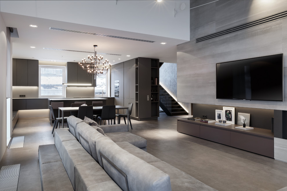 Идея дизайна: парадная, открытая гостиная комната в современном стиле с серыми стенами, телевизором на стене и серым полом