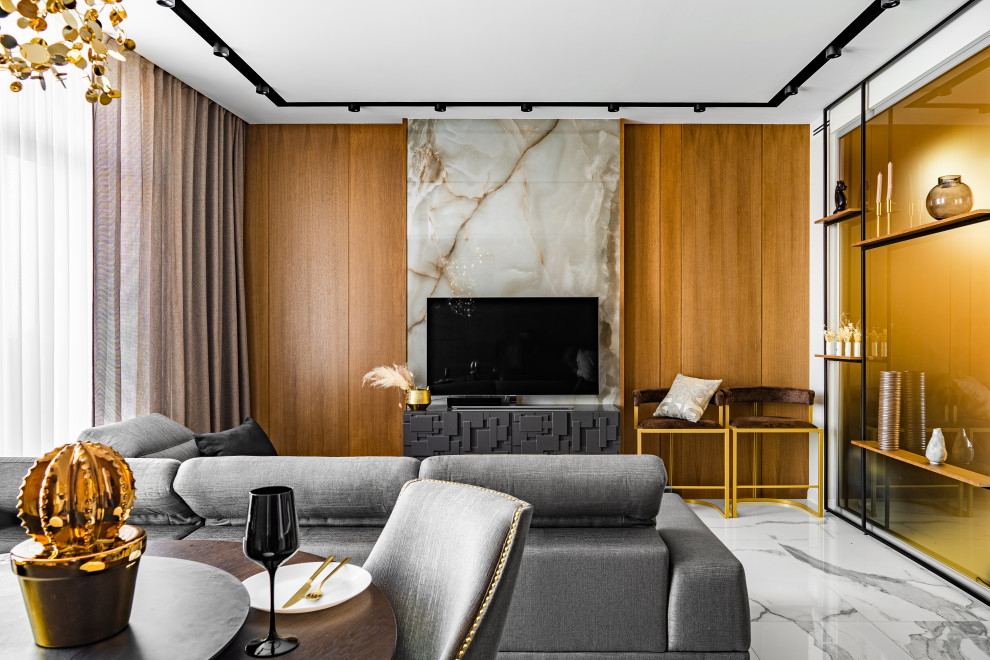 На фото: гостиная комната среднего размера в современном стиле с полом из керамогранита и телевизором на стене с