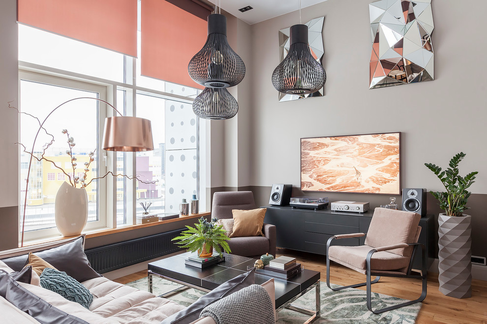 Photo of a medium sized contemporary open plan living room in Other with grey walls, medium hardwood flooring, a wall mounted tv, brown floors and feature lighting.