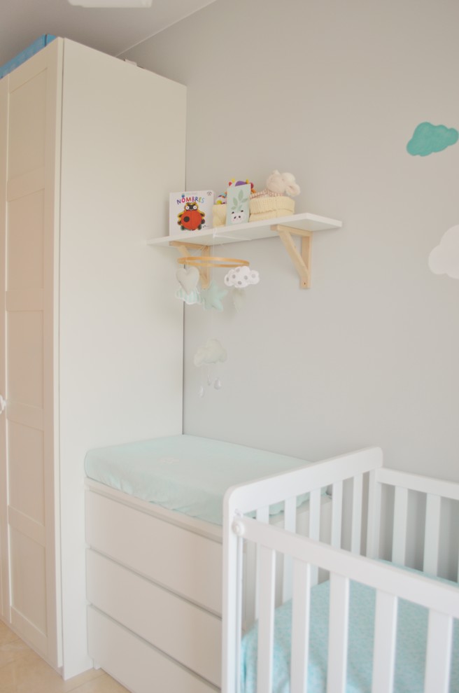 Imagen de habitación de bebé neutra escandinava pequeña con paredes grises, suelo de baldosas de porcelana y suelo beige