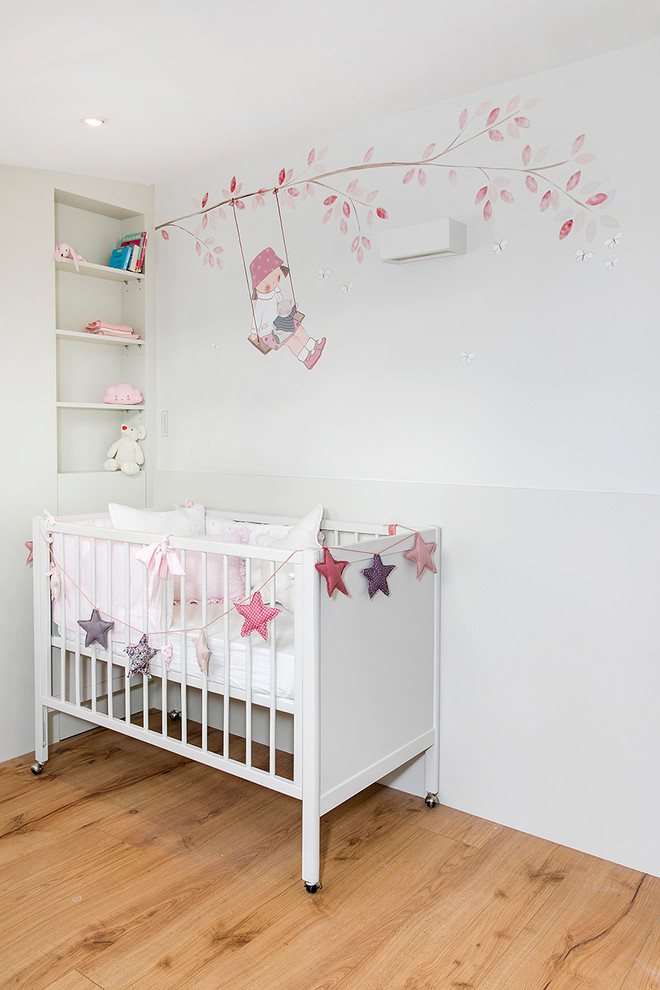 Photo of a vintage nursery for girls with beige walls.