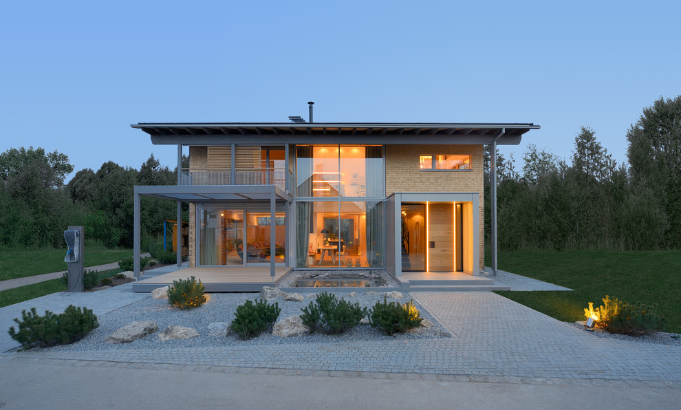 Свежая идея для дизайна: двухэтажный, деревянный, бежевый дом в современном стиле с двускатной крышей - отличное фото интерьера