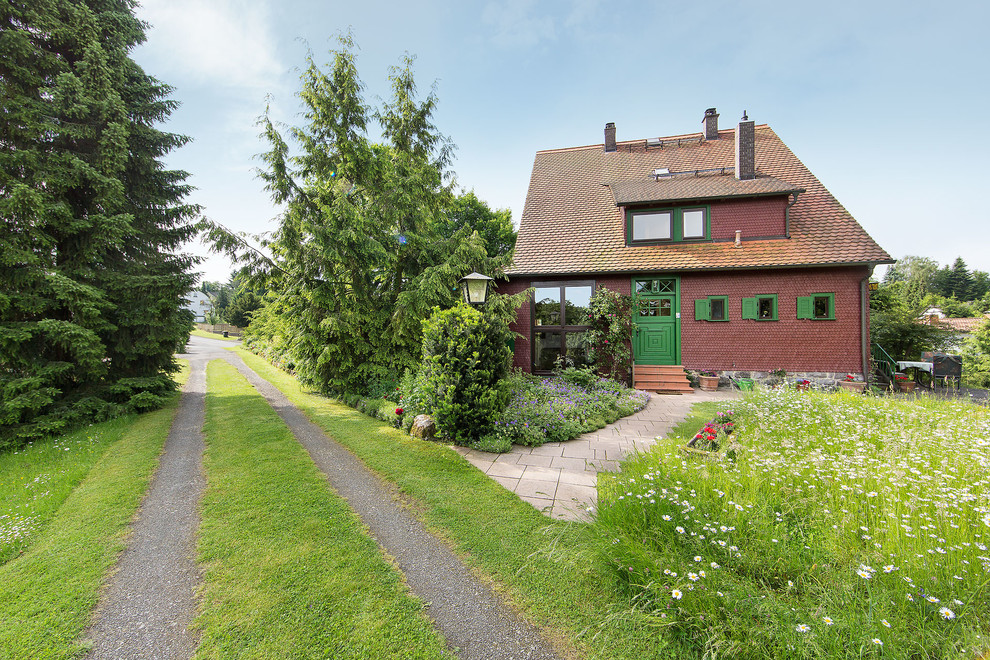 Country red one-story house exterior photo in Stuttgart