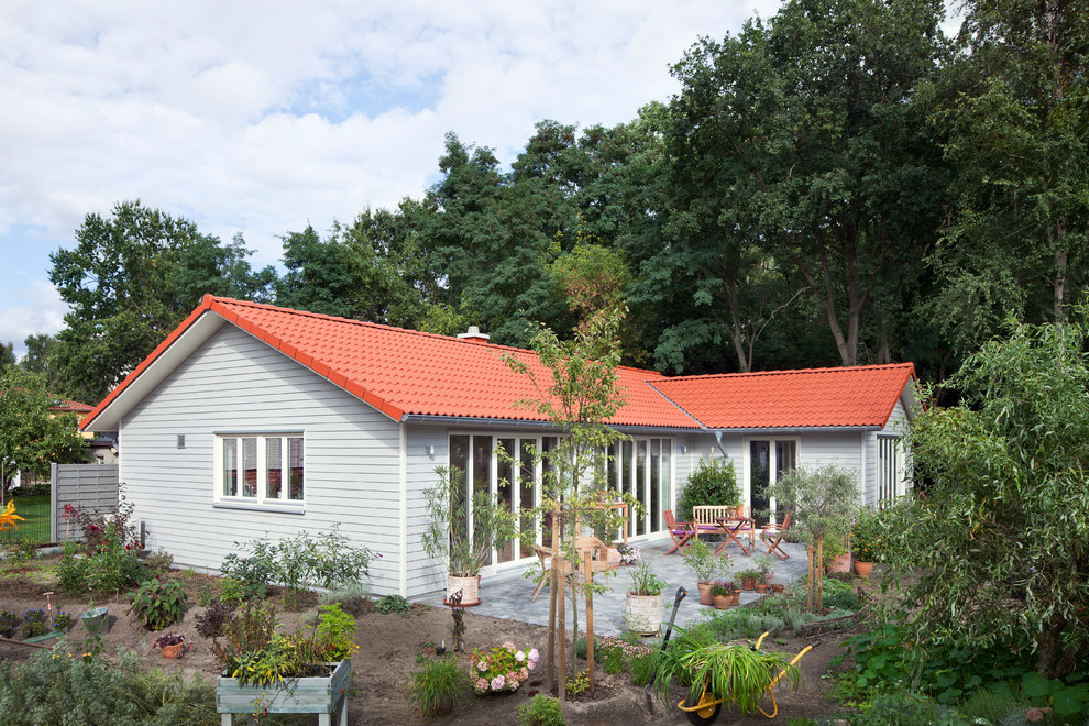 Idées déco pour une façade de maison grise campagne en bois de plain-pied avec un toit en tuile.