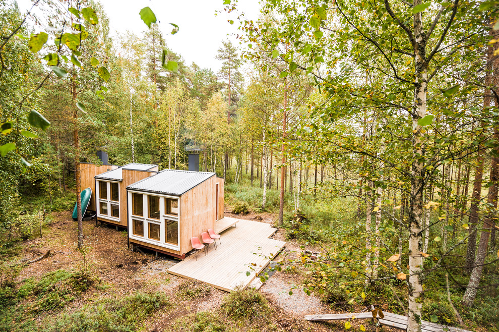 Foto della casa con tetto a falda unica piccolo scandinavo a un piano con rivestimento in legno e copertura in metallo o lamiera