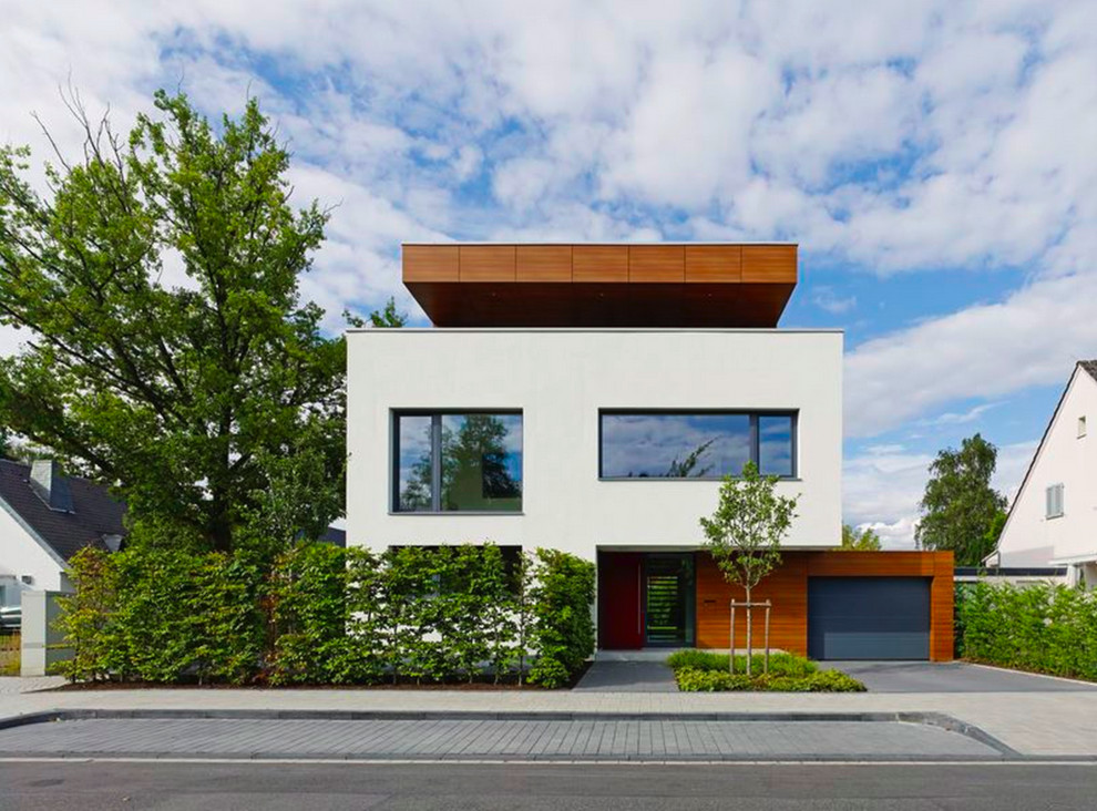 Идея дизайна: двухэтажный, белый дом среднего размера в стиле модернизм с комбинированной облицовкой и плоской крышей
