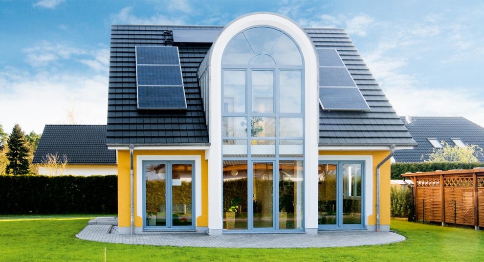 Exemple d'une façade de maison jaune tendance en stuc de taille moyenne et à un étage avec un toit à deux pans.