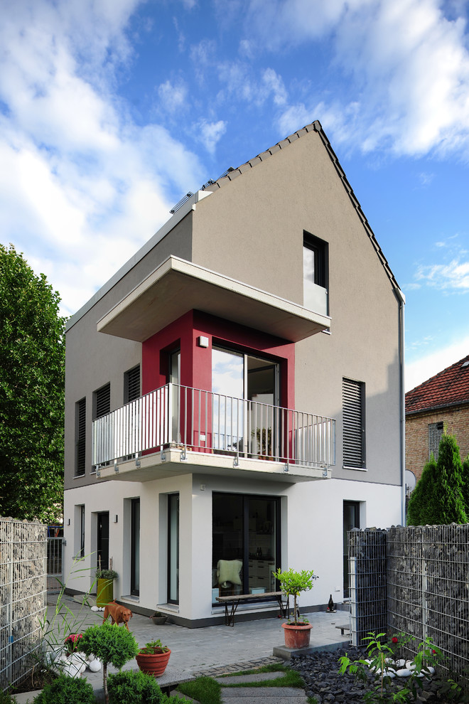 Kleines, Dreistöckiges Modernes Einfamilienhaus mit Putzfassade, grauer Fassadenfarbe, Satteldach und Ziegeldach in Frankfurt am Main
