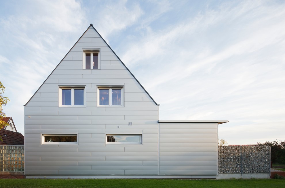 Mittelgroßes, Dreistöckiges Klassisches Haus mit Metallfassade, grauer Fassadenfarbe und Satteldach in Stuttgart
