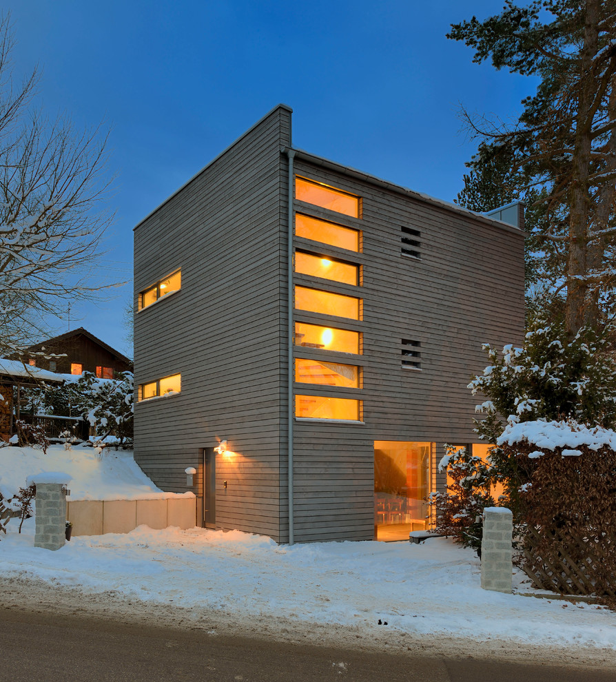 Idee per la facciata di una casa piccola scandinava a tre piani con tetto piano e rivestimento in legno