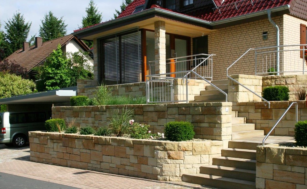 Photo of a large and beige rustic detached house in Frankfurt with three floors, stone cladding, a pitched roof and a tiled roof.