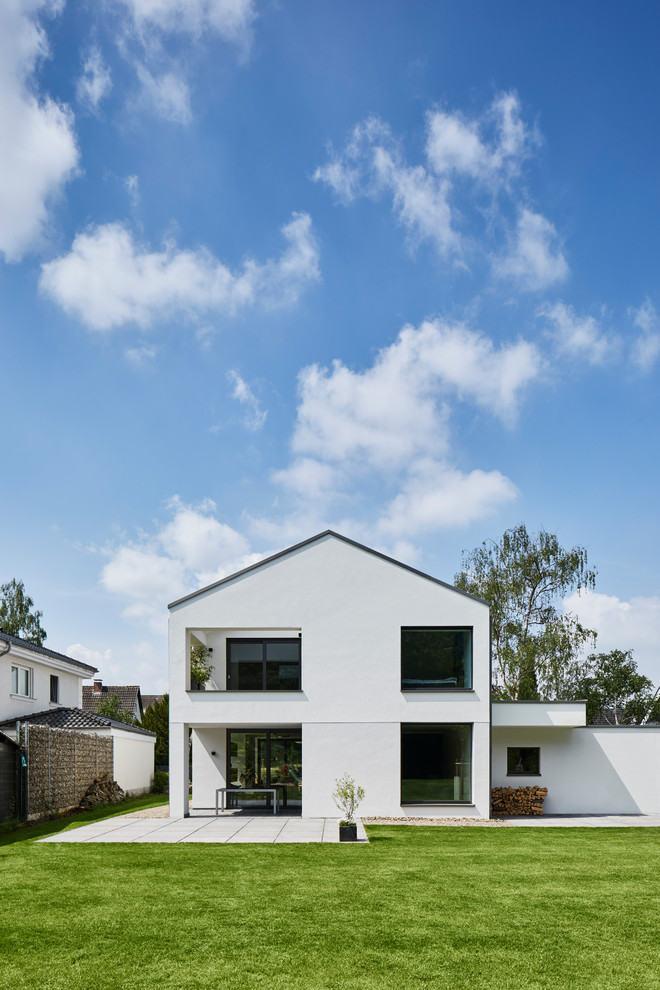 На фото: белый, двухэтажный, большой частный загородный дом в стиле кантри с облицовкой из камня, двускатной крышей и черепичной крышей