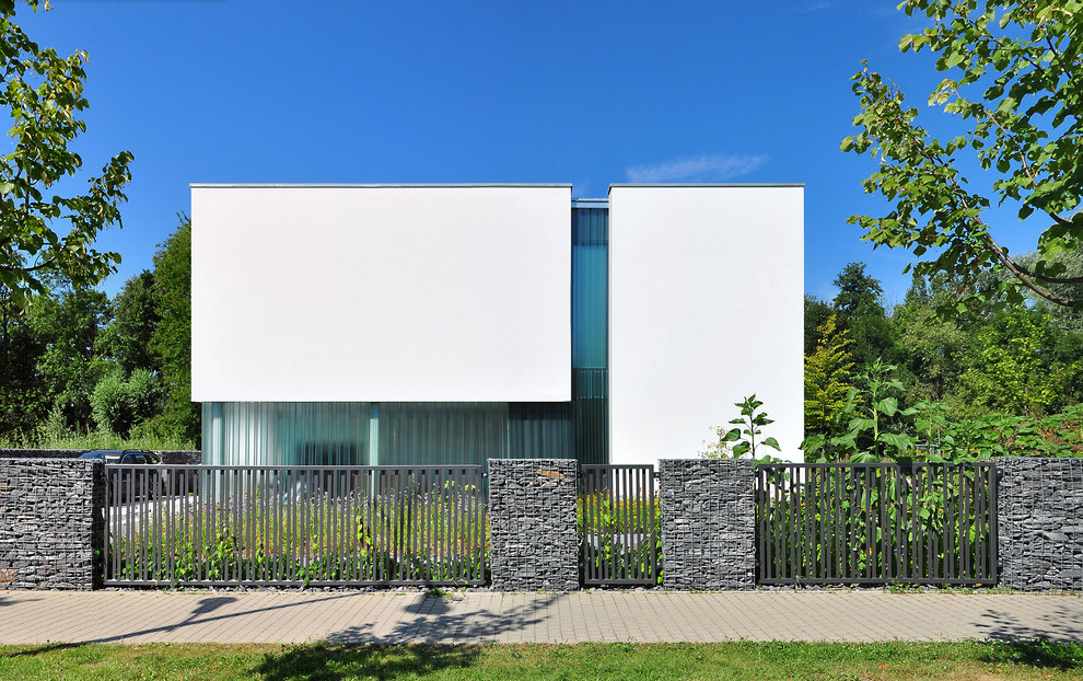 Mid-sized modern white two-story flat roof idea in Leipzig