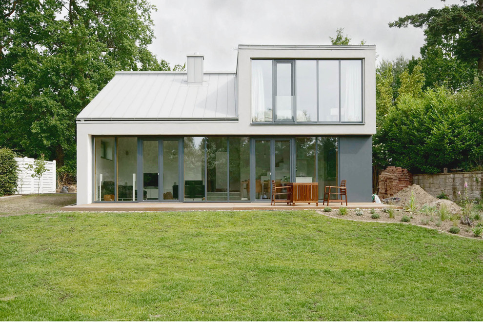 This is an example of a large contemporary two floor glass house exterior in Hanover with a pitched roof.