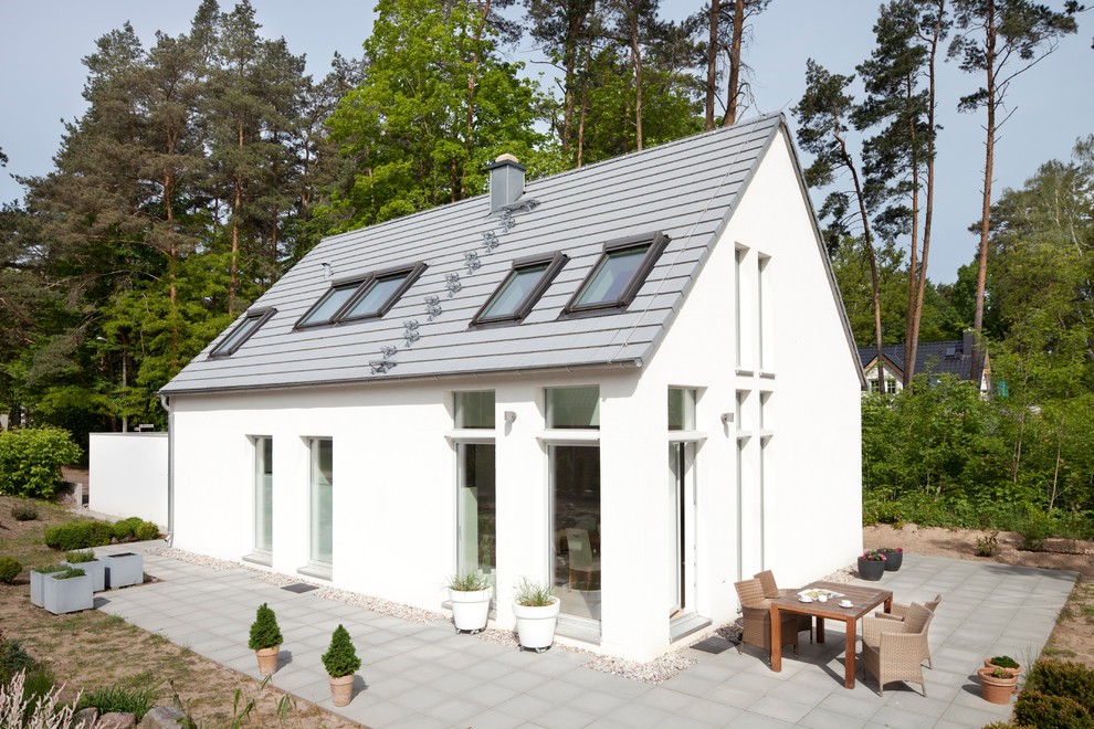 Kleines, Zweistöckiges Modernes Haus mit weißer Fassadenfarbe und Satteldach in Berlin