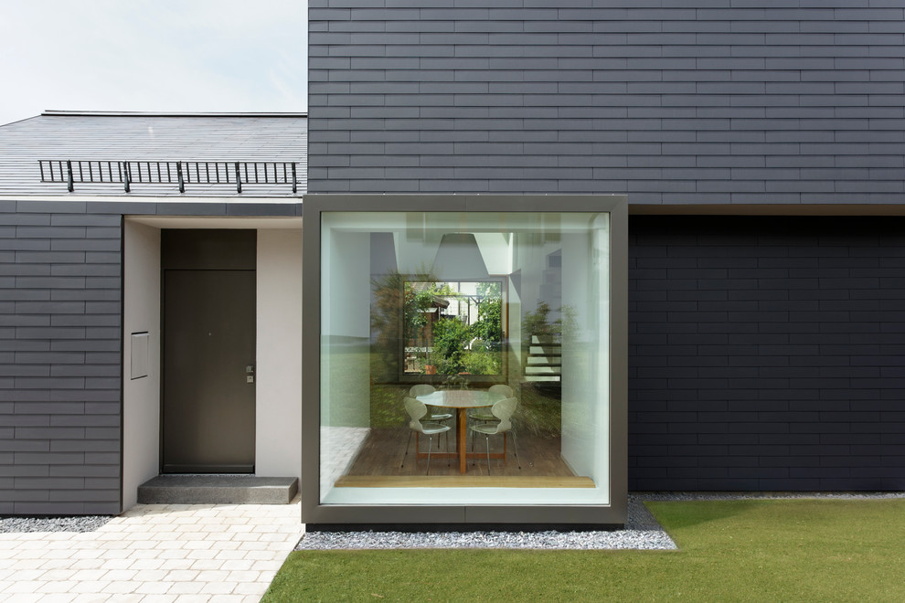 This is an example of a small and gey contemporary two floor house exterior in Cologne.