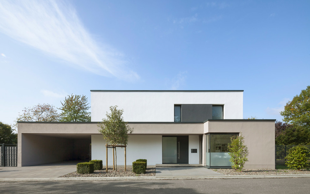 White modern two floor house exterior in Cologne with a flat roof.