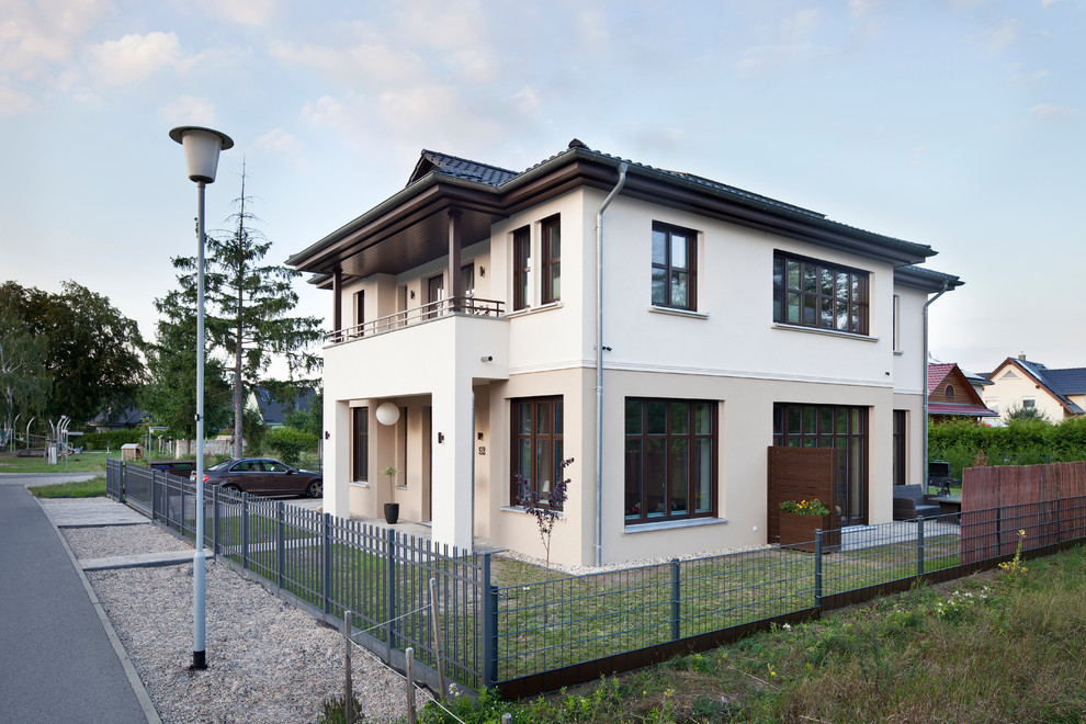 Large and brown traditional two floor house exterior in Berlin with a hip roof.