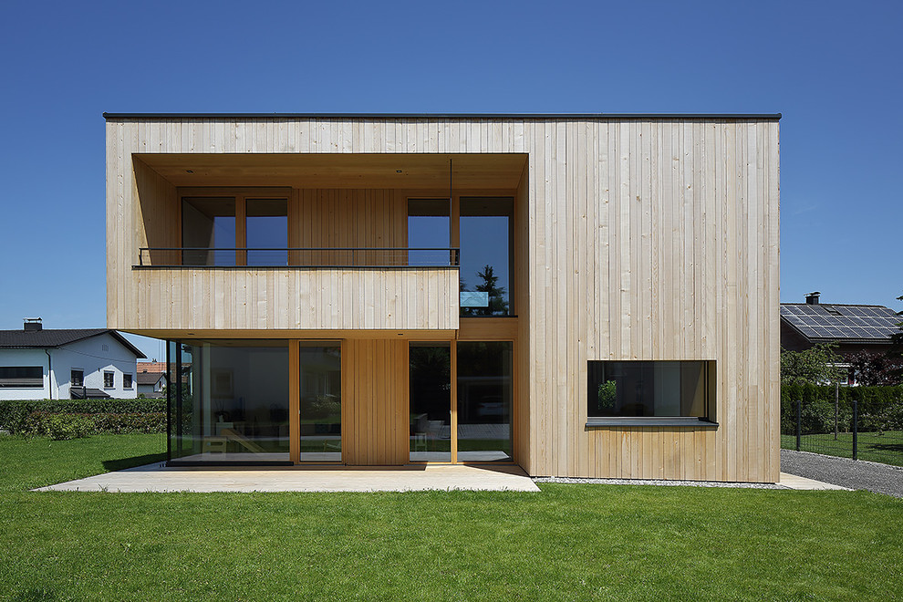 Пример оригинального дизайна: деревянный, бежевый, двухэтажный дом среднего размера в современном стиле с плоской крышей