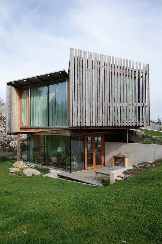 Imagen de fachada marrón contemporánea pequeña de dos plantas con revestimiento de madera y tejado de un solo tendido