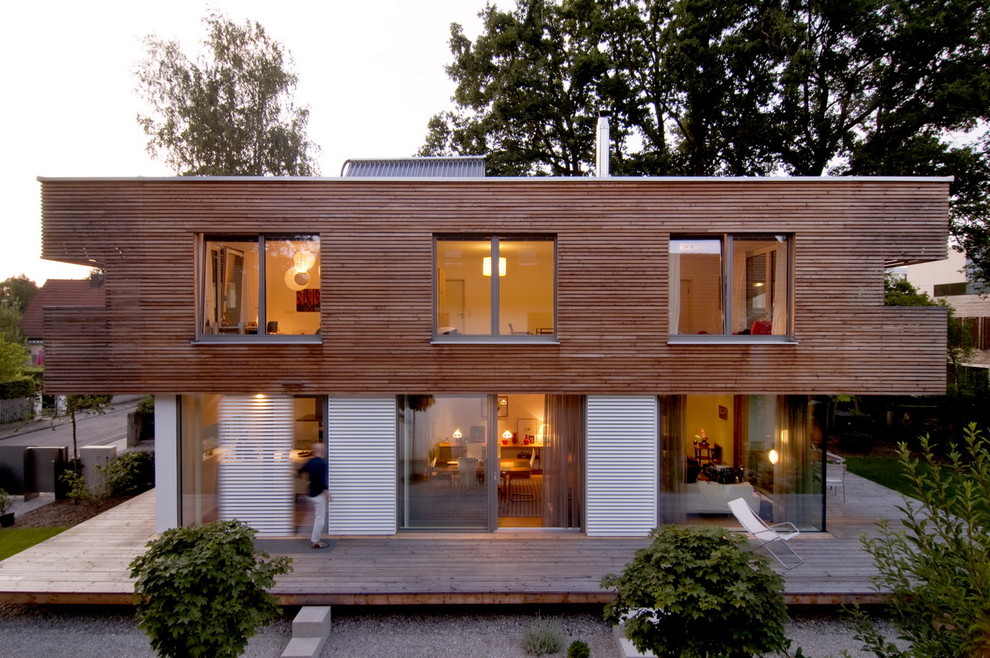 Ejemplo de fachada contemporánea de tamaño medio de dos plantas con revestimiento de madera y tejado plano