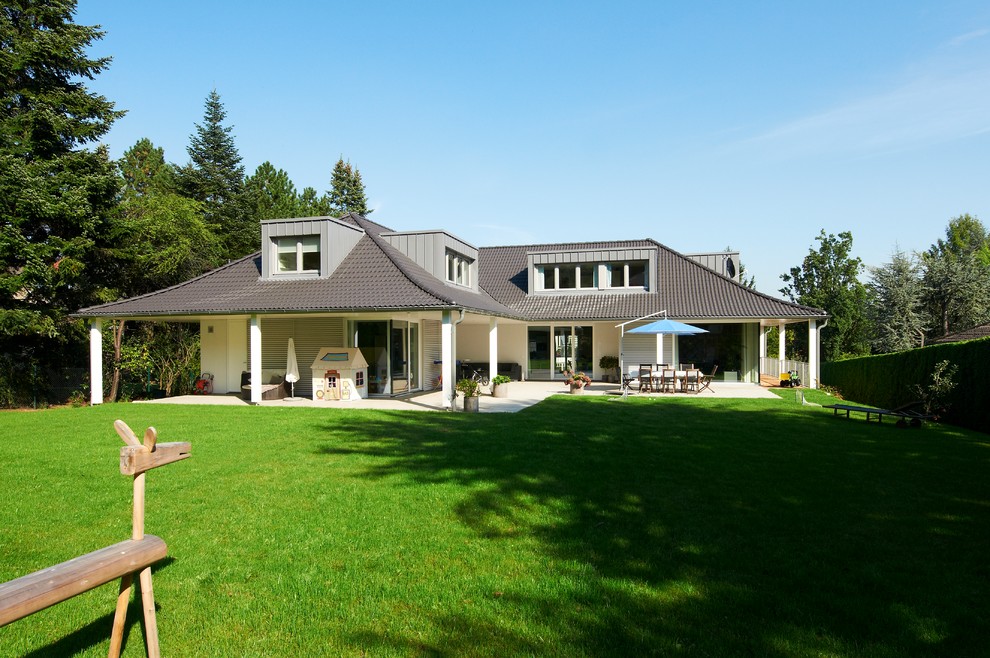 Inspiration for a transitional white two-story stucco exterior home remodel in Stuttgart with a tile roof