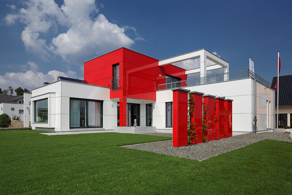 Inspiration för ett mellanstort funkis rött hus, med två våningar och platt tak
