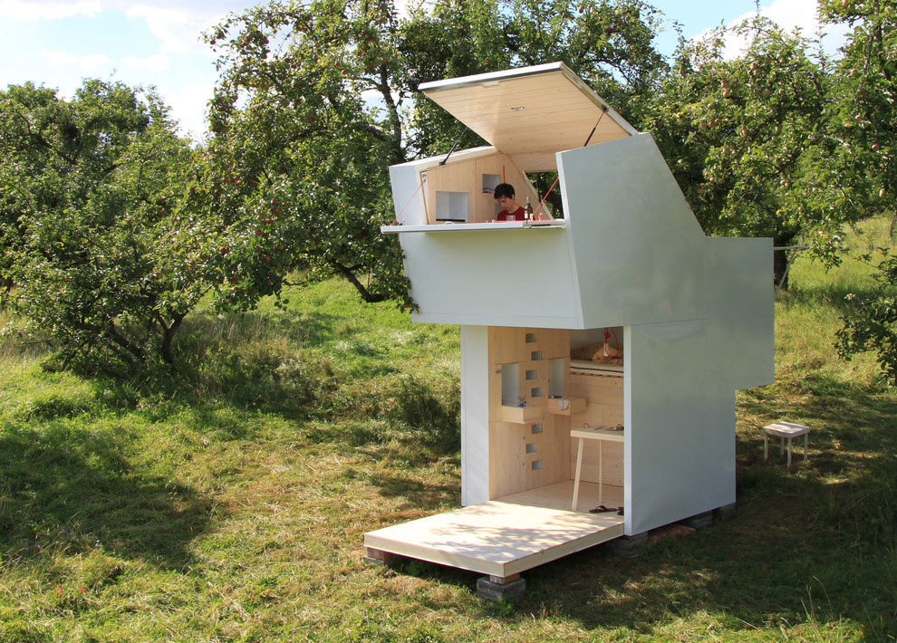 Small trendy white split-level wood exterior home photo in Munich