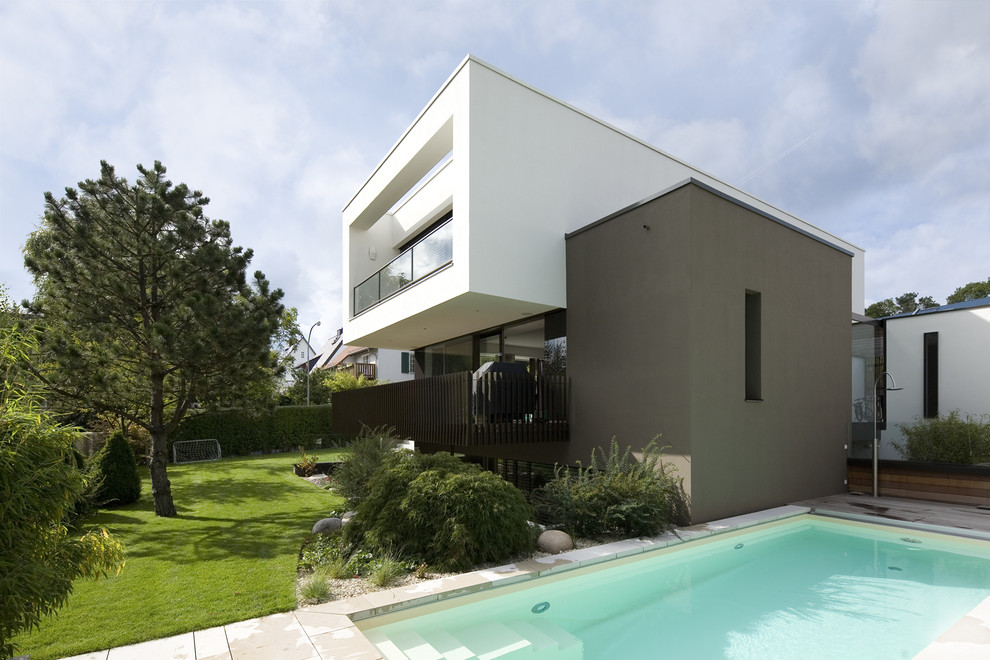 Inspiration for a mid-sized contemporary white two-story flat roof remodel in Frankfurt