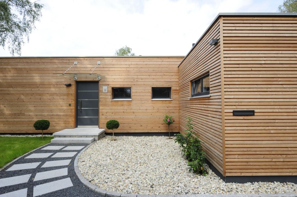 Esempio della facciata di una casa marrone contemporanea a un piano di medie dimensioni con rivestimento in legno e tetto piano