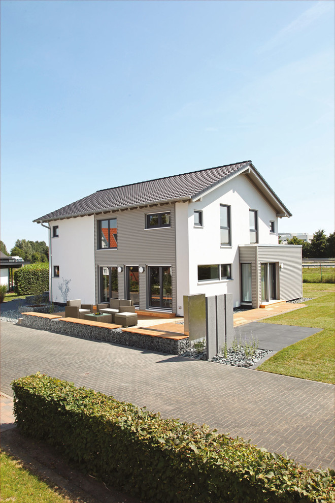 Photo of a white contemporary two floor render detached house in Other with a pitched roof and a tiled roof.
