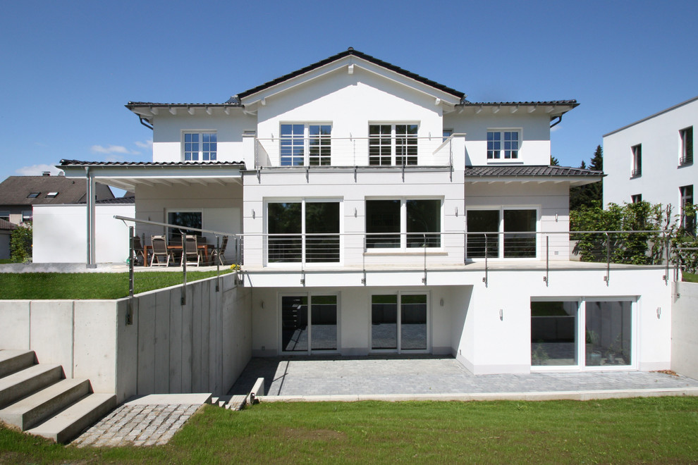 White and large classic house exterior in Dortmund with three floors.