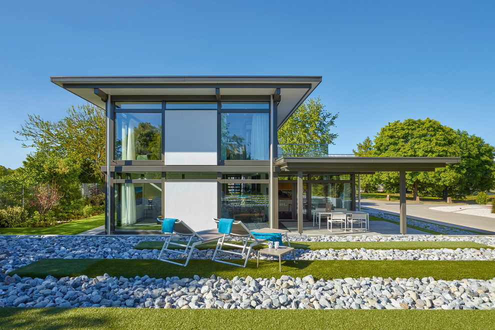 Foto de fachada de casa blanca contemporánea de dos plantas con revestimientos combinados y tejado plano
