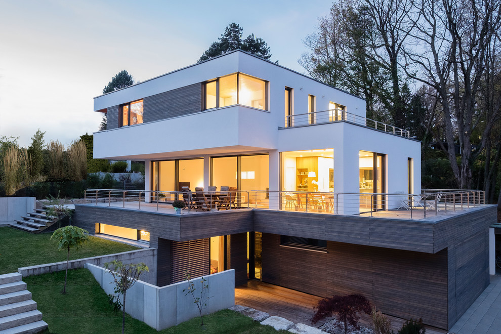 Design ideas for a large and white contemporary detached house in Munich with three floors, mixed cladding and a flat roof.