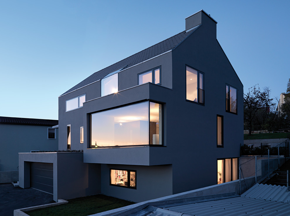 Mid-sized modern three-story gable roof idea in Stuttgart