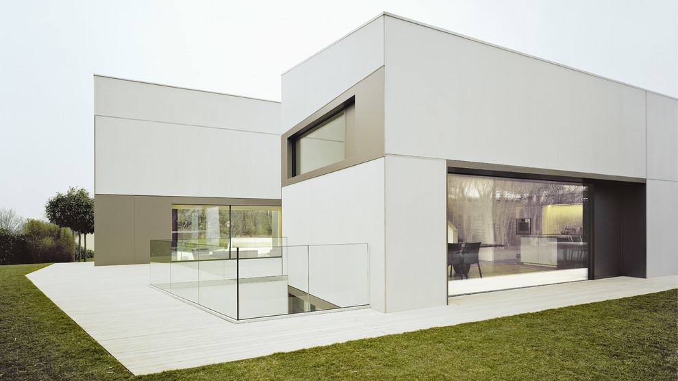 Inspiration for a large and white contemporary two floor house exterior in Stuttgart with concrete fibreboard cladding and a lean-to roof.