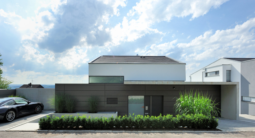 На фото: коричневый, огромный, двухэтажный дом в современном стиле с комбинированной облицовкой и двускатной крышей