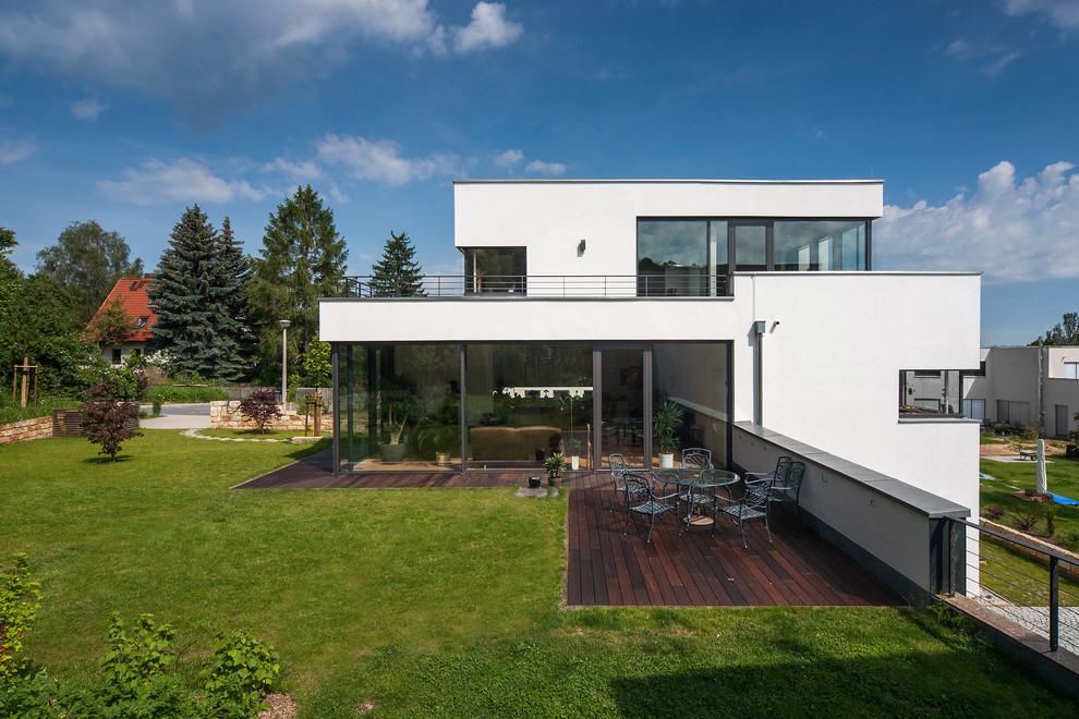This is an example of a white and large modern house exterior in Other with three floors and a flat roof.